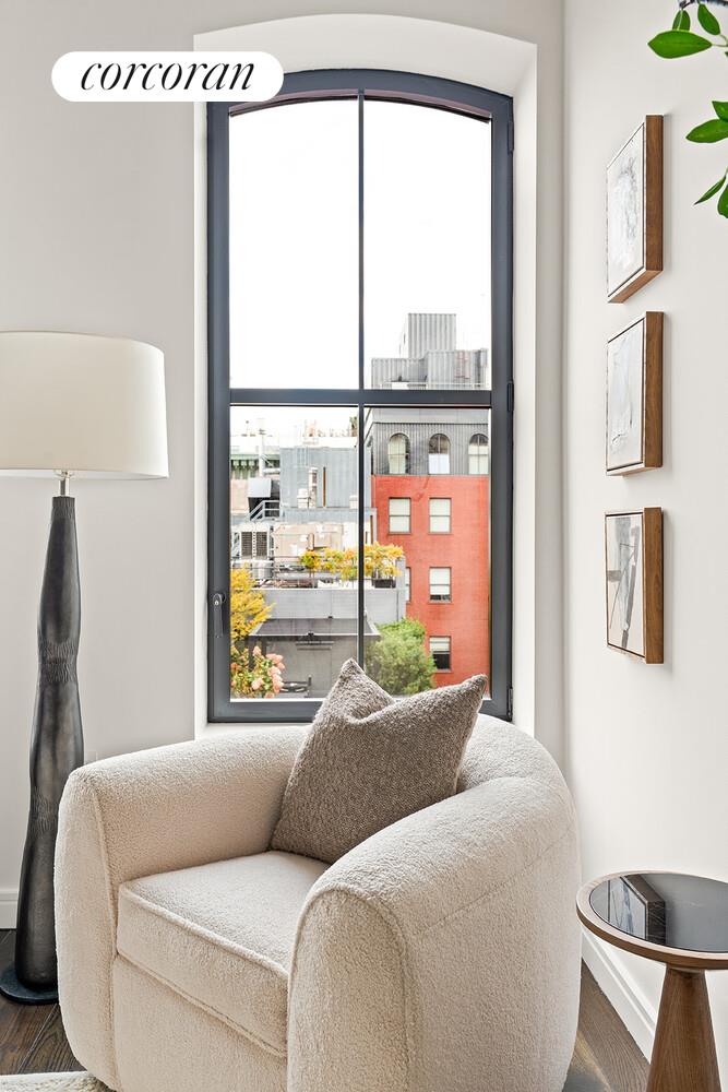 250 West Street, Unit 8H Manhattan, NY 10013 - Photo 8 of 16 a living room with a couch and a large window
