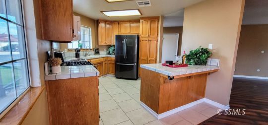 705 Ginger Avenue Ridgecrest, CA 93555 - Photo 5 of 21 a kitchen with stainless steel appliances granite countertop a refrigerator and a stove
