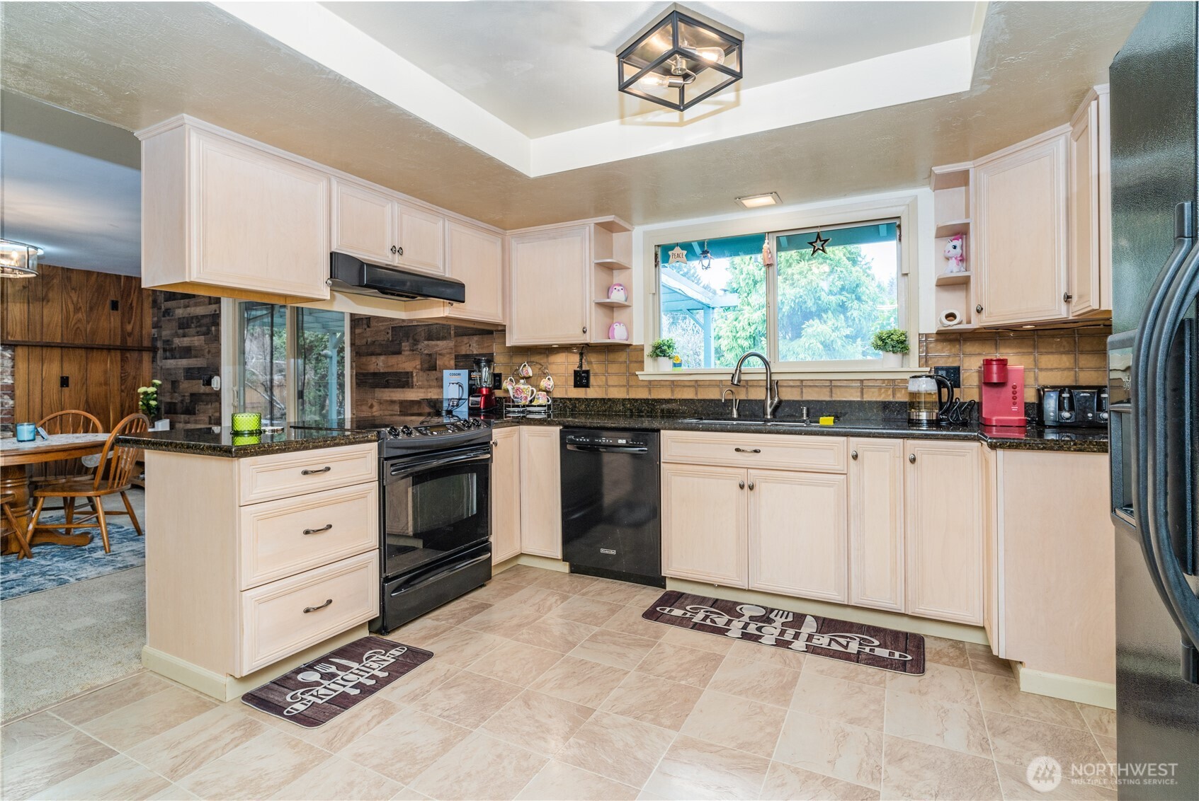 1215 Dundee Drive Cosmopolis, WA 98537 - Photo 13 of 30 a kitchen with granite countertop a stove a sink and a refrigerator