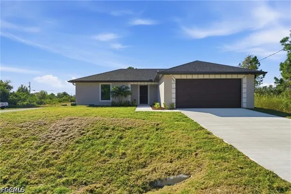 a front door view of a house with a yard