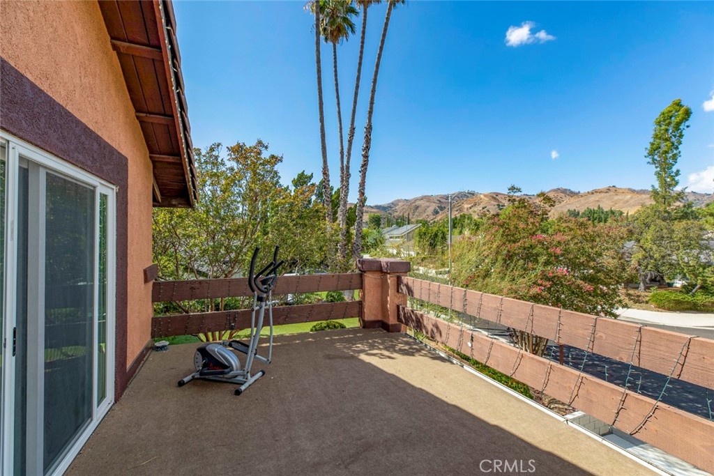18810 Kirkcolm Lane Porter Ranch, CA 91326 - Photo 29 of 75 a view of balcony with furniture and trees