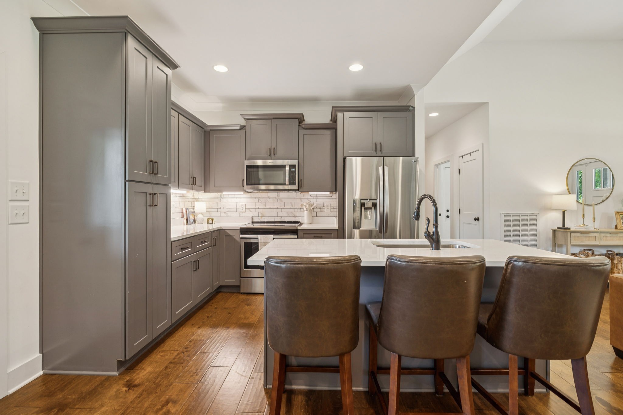 760 Johnson Hollow Road Watertown, TN 37184 - Photo 10 of 53 a kitchen with kitchen island wooden cabinets a refrigerator a stove a dining table and chairs