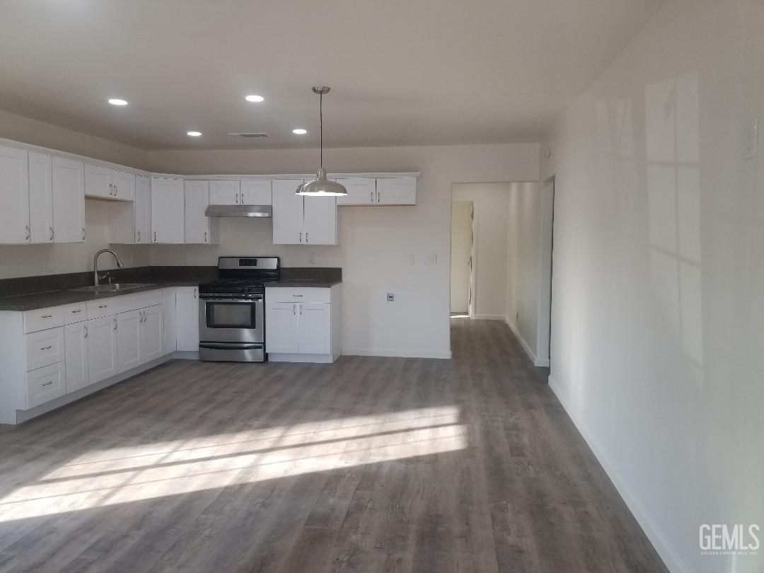 Undisclosed Address Delano, CA 93215 - Photo 3 of 10 a kitchen with stainless steel appliances granite countertop a stove a sink and a refrigerator