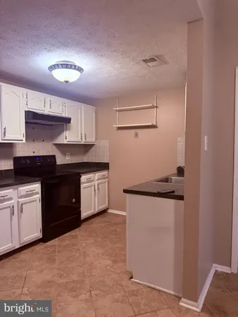 a kitchen with stainless steel appliances a sink and a refrigerator