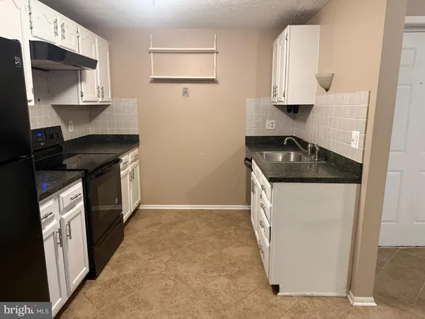 a kitchen with a stove and a refrigerator