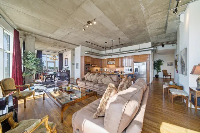 a living room with lots of furniture and a large window