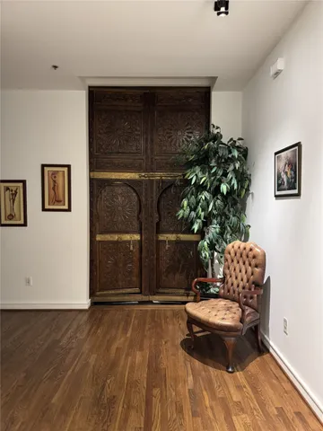 a living room with a couch and a potted plant