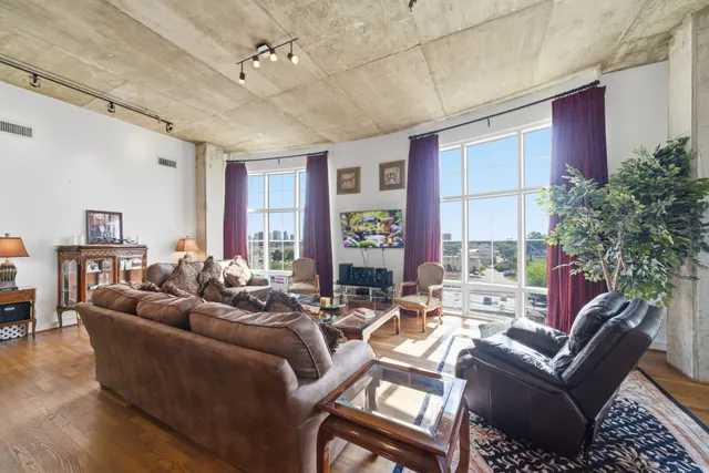 a living room with lots of furniture and a chandelier