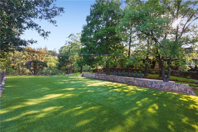 a front view of house with wooden fence next to a yard