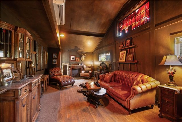 a living room with furniture a ceiling fan and a window