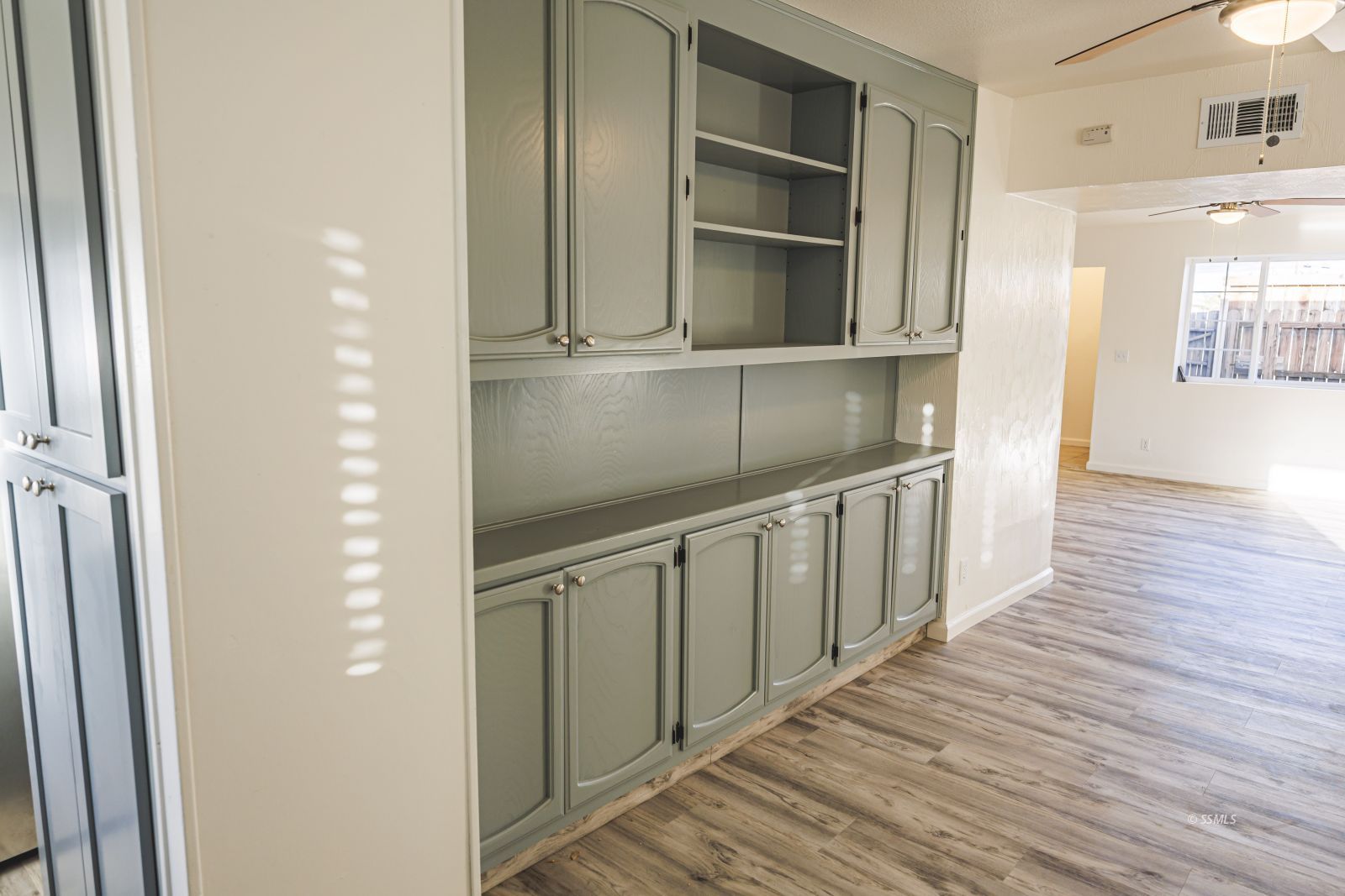 1213 Primrose Street Ridgecrest, CA 93555 - Photo 9 of 37 a hallway with wooden floors and cabinet