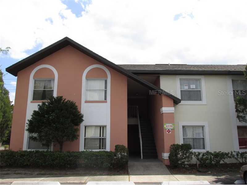4338 Pershing Pointe Place, Unit 4 Orlando, FL 32822 - Photo 1 of 1 a front view of a house with a yard