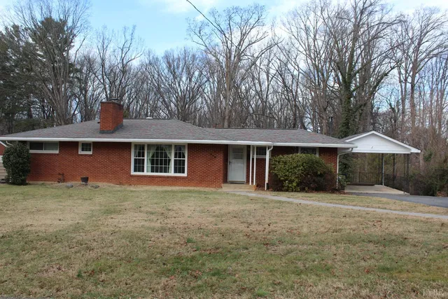 a front view of house with yard and trees