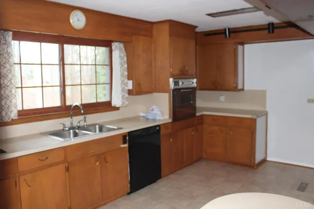 a kitchen with granite countertop a sink and a stove