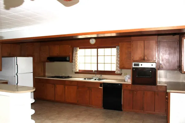 a kitchen with a sink a refrigerator and a stove
