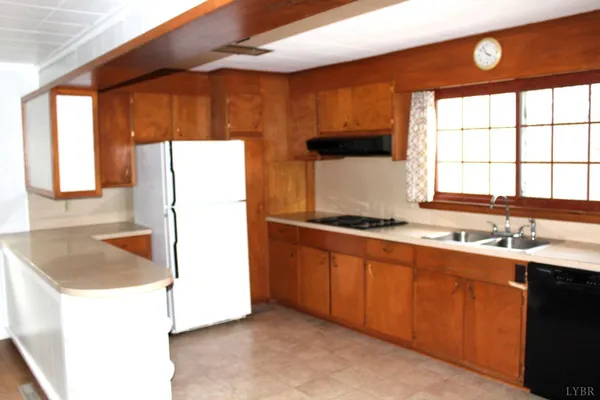 a kitchen with a sink a counter top space and a window