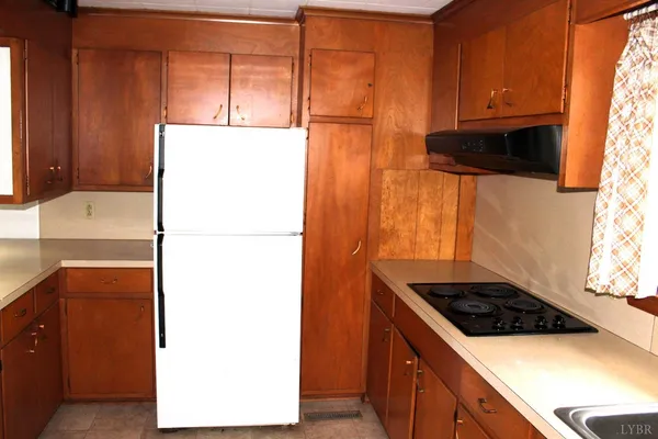an empty room with a fireplace and cabinet