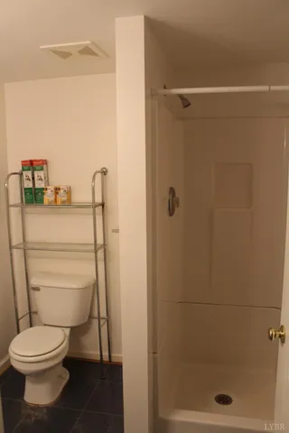 a bathroom with a toilet and a shower