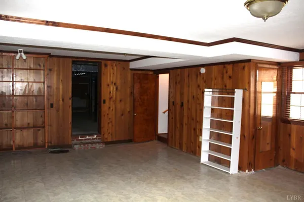 a view of a room with wooden floor and a window