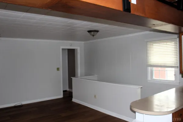 a view of a livingroom with wooden floor and a ceiling fan