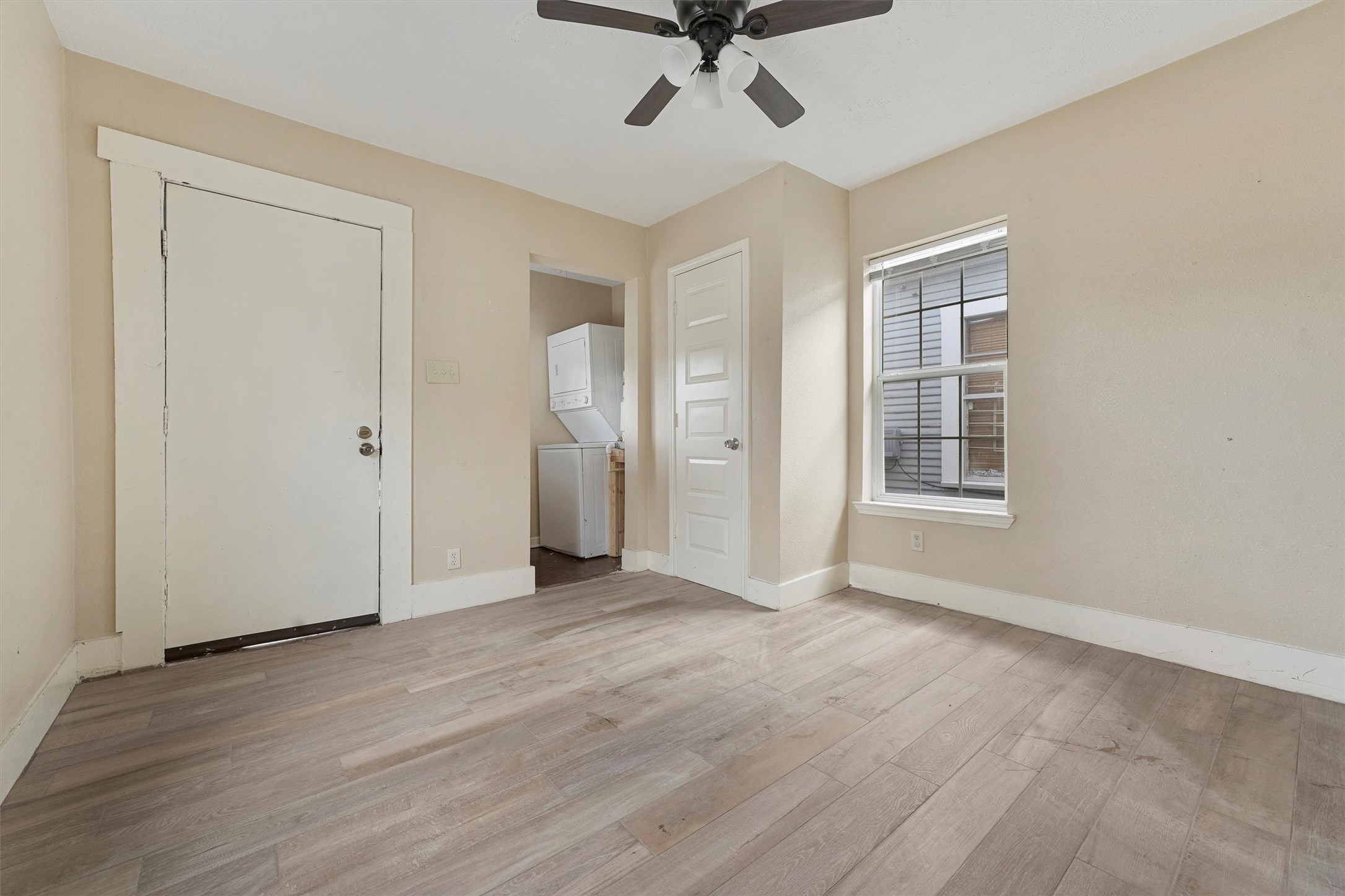 3706 Delano Street Houston, TX 77004 - Photo 9 of 21 an empty room with wooden floor ceiling fan and windows
