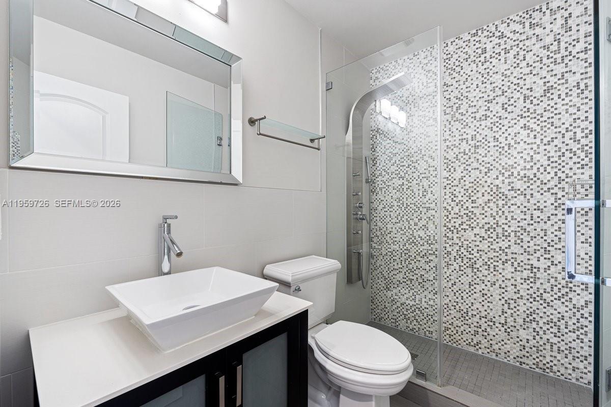 4978 Southwest 35th Terrace Hollywood, FL 33312 - Photo 17 of 24 a bathroom with a sink a toilet and a mirror