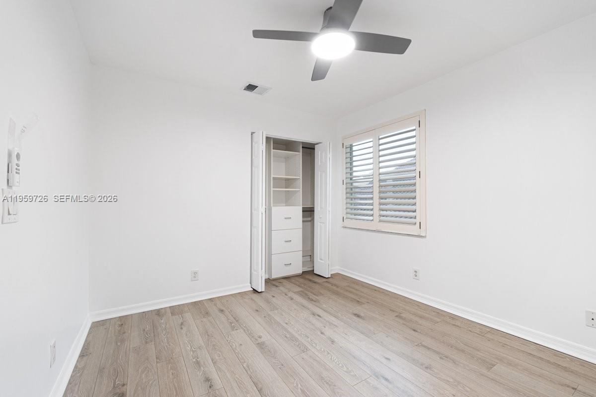 4978 Southwest 35th Terrace Hollywood, FL 33312 - Photo 19 of 24 an empty room with wooden floor and windows