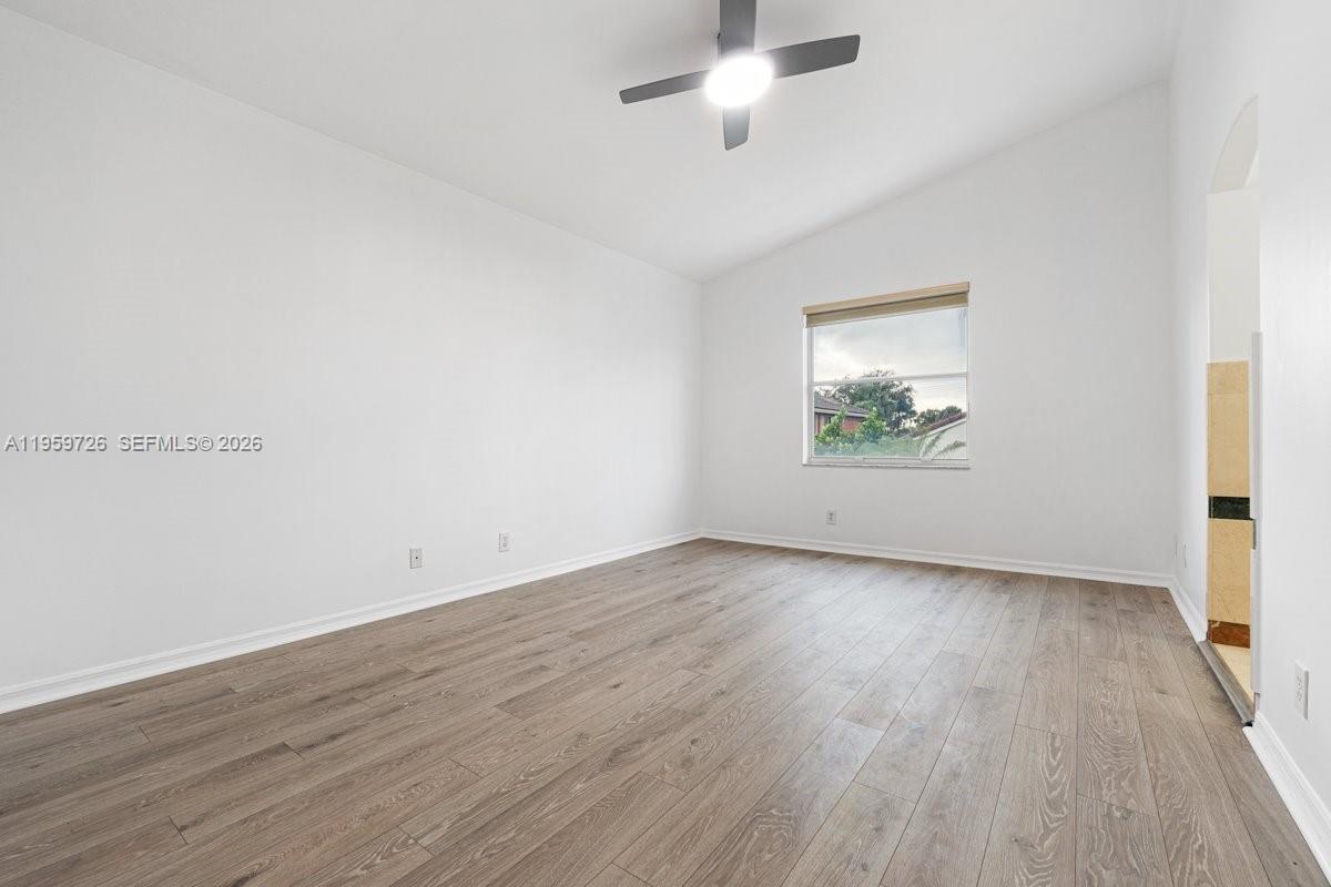 4978 Southwest 35th Terrace Hollywood, FL 33312 - Photo 21 of 24 an empty room with wooden floor and windows