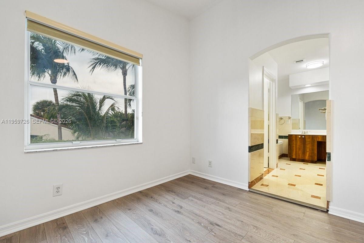 4978 Southwest 35th Terrace Hollywood, FL 33312 - Photo 23 of 24 a view of a room with wooden floor and a bed