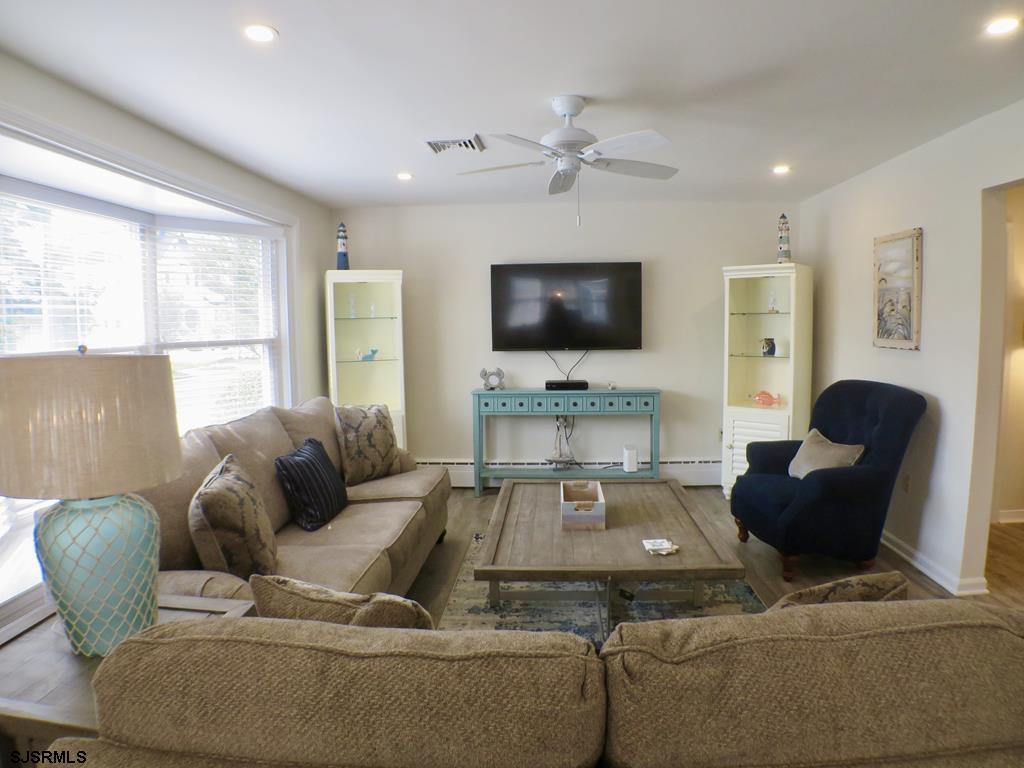 814 Wesley Road Ocean City, NJ 08226 - Photo 6 of 29 a living room with furniture and a flat screen tv