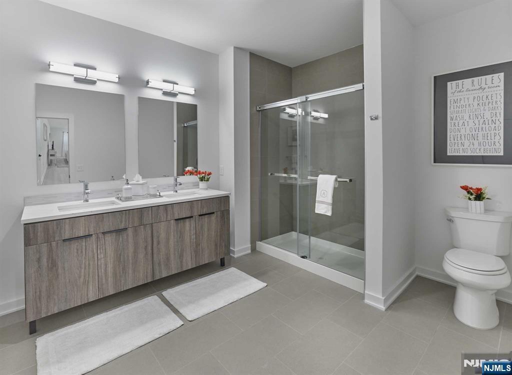 8 Tice Road, Unit 205 Franklin Lakes, NJ 07417 - Photo 15 of 29 a bathroom with a double vanity sink toilet and shower