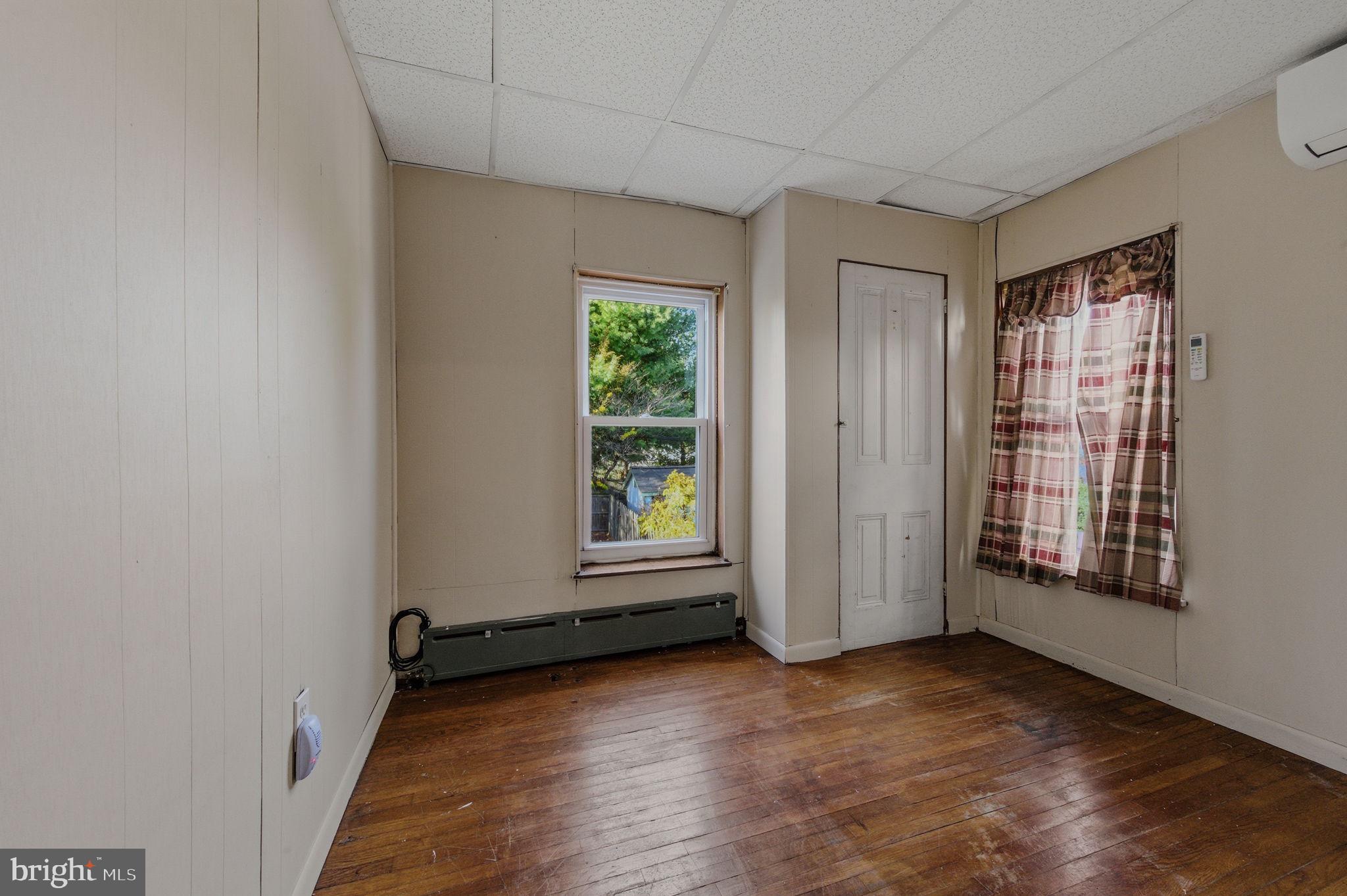 1905 North Scott Street Wilmington, DE 19806 - Photo 14 of 29 an empty room with wooden floor and windows