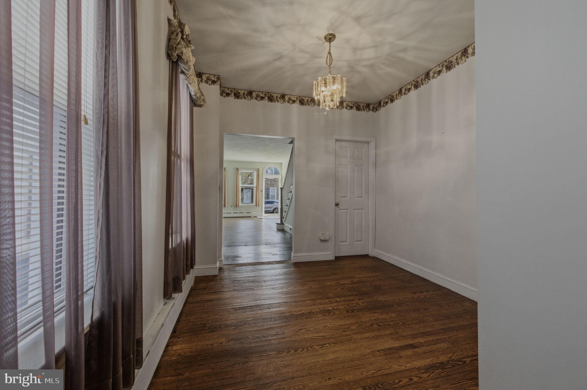 1905 North Scott Street Wilmington, DE 19806 - Photo 8 of 29 a view of a hallway with wooden floor and chandelier