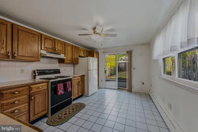 a kitchen with a cabinets appliances and a counter top space