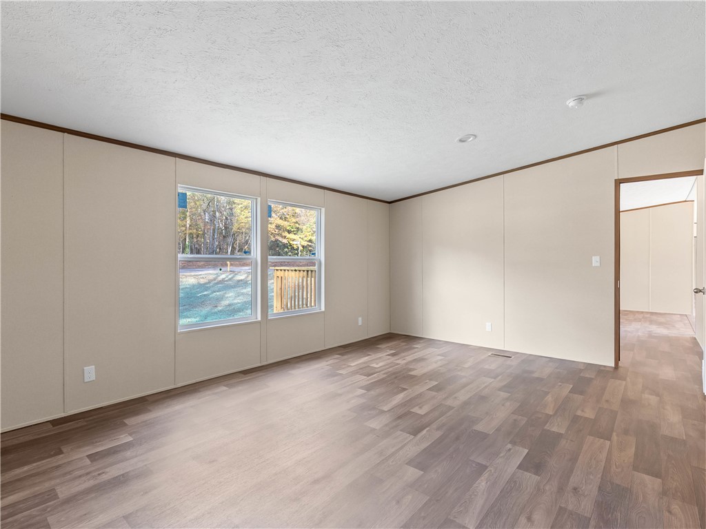 401 Mormon Church Road Seneca, SC 29678 - Photo 18 of 43 This bright, airy room offers a welcoming atmosphere and durable flooring, ready for your personal touch.