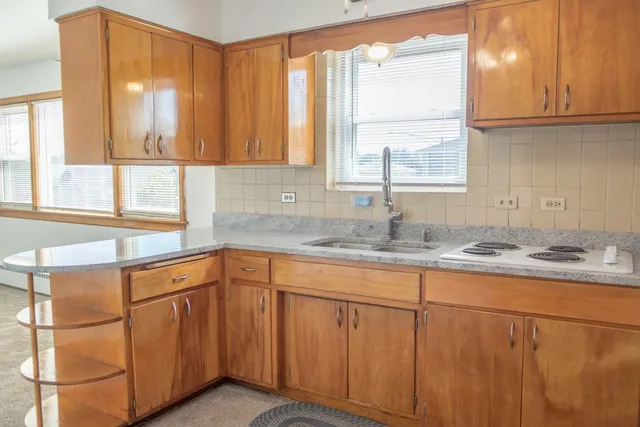 a kitchen with stainless steel appliances granite countertop a sink and a window