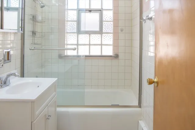 a bath room with a sink and a bath tub