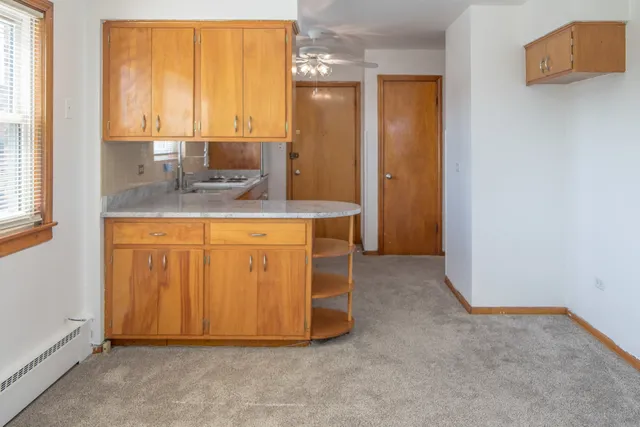 a view of kitchen with granite countertop cabinets and sink
