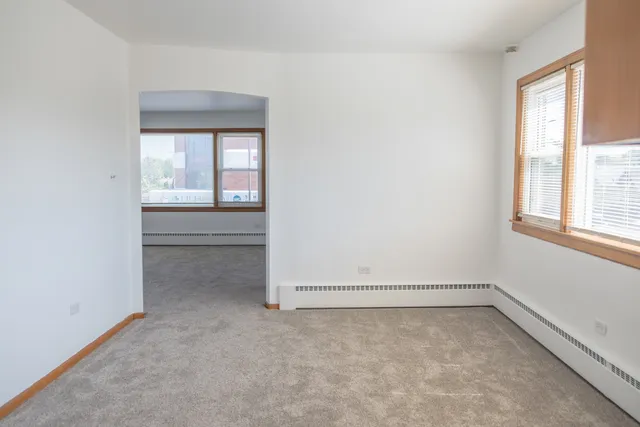 an empty room with a empty space and windows