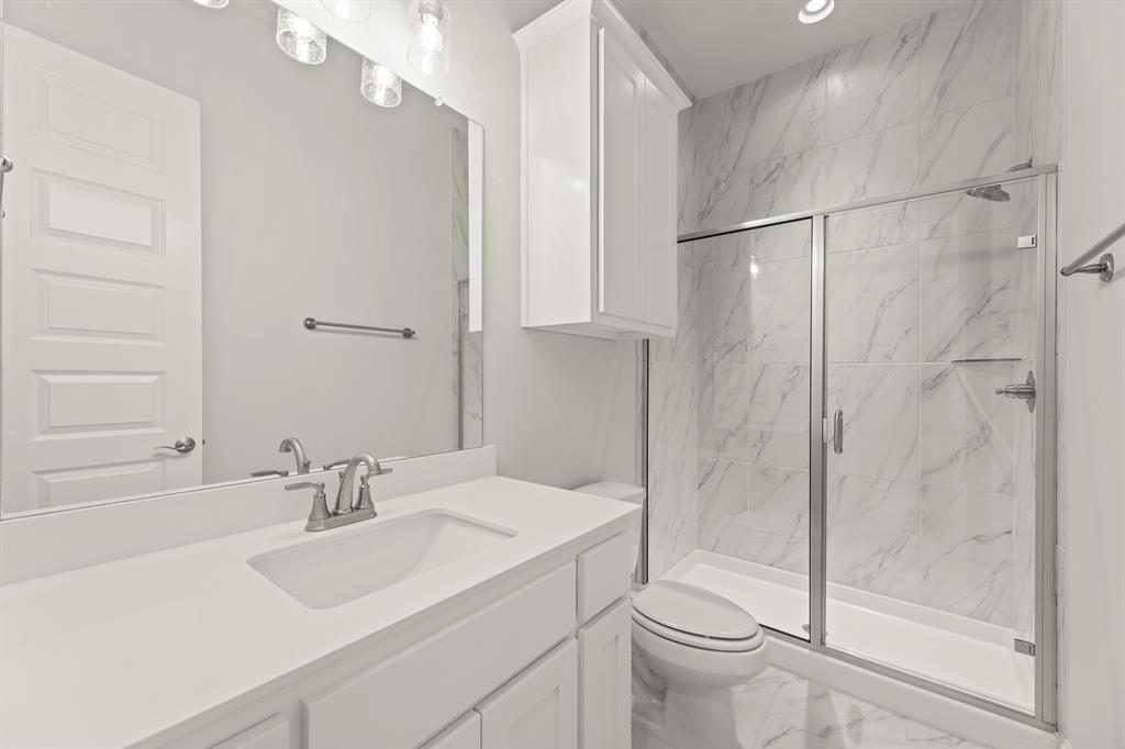 3802 Windmere Drive Rowlett, TX 75088 - Photo 15 of 34 a bathroom with a sink toilet and shower