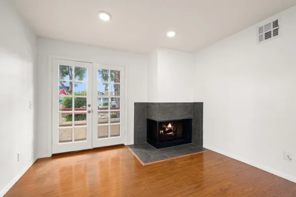 an empty room with a fireplace and window