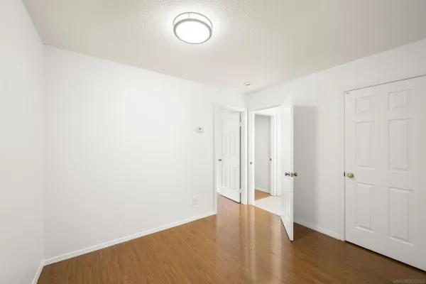a view of a room with wooden floor