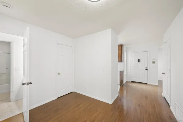 a view of a room with wooden floor