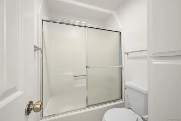 a bathroom that has a glass shower door