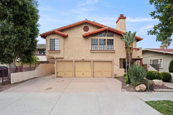 a view of a house with a yard and plants