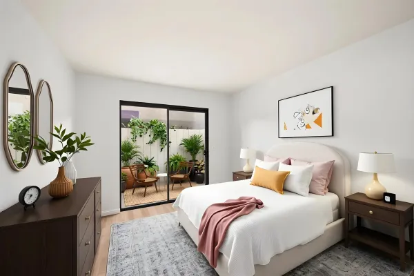 a bedroom with a large bed and a potted plant