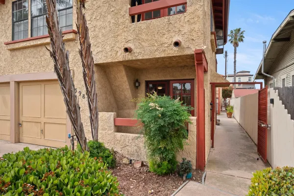 a front view of a house with plants