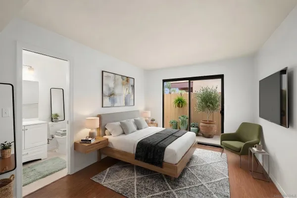 a bedroom with a bed a large window and glass door