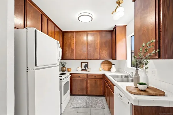 a kitchen with stainless steel appliances a sink and a refrigerator
