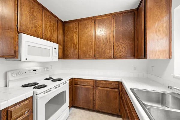 a kitchen with a sink cabinets and stainless steel appliances
